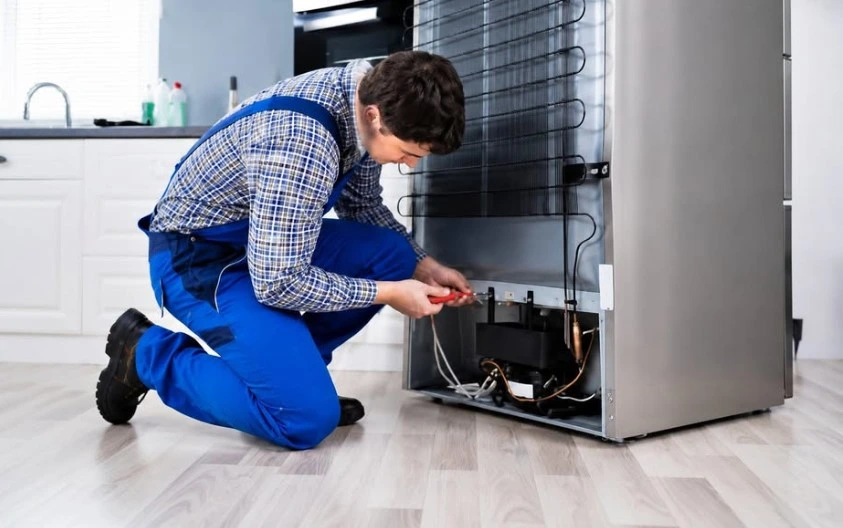 Factory-trained appliance repair technician performing diagnostics on a home appliance in Klamath