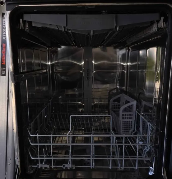 Professional technician repairing a leaking dishwasher in a Klamath Falls, OR kitchen.