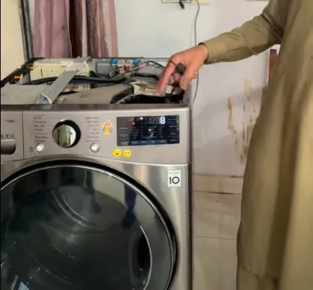Alt Text Technician repairing a dryer that won't start in a Klamath Falls, OR home.
