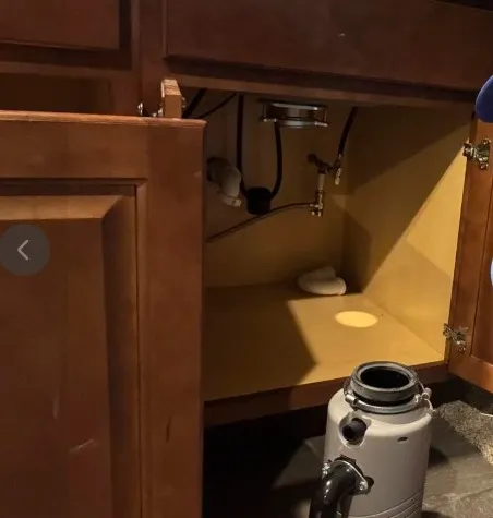 Technician repairing a garbage disposal that won't turn on in Klamath Falls, OR.