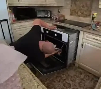 Technician repairing an oven that is not heating properly in a Klamath Falls, OR home.