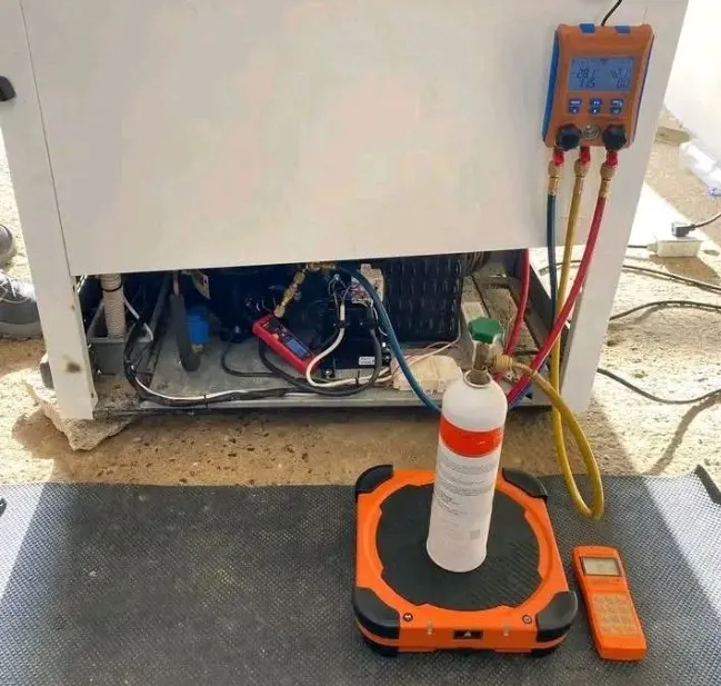 Technician diagnosing a refrigerator making loud buzzing and rattling noises in Klamath Falls, OR.