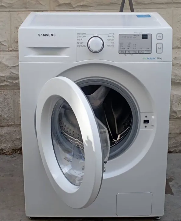 Technician repairing a washing machine that is not draining in Klamath Falls, OR.