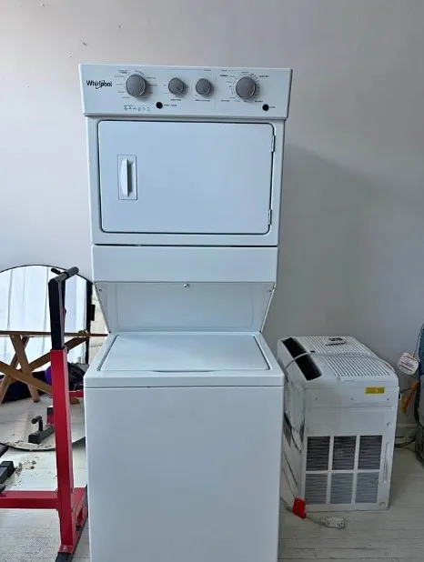 Technician repairing a washing machine that stops mid-cycle in Klamath Falls, OR.