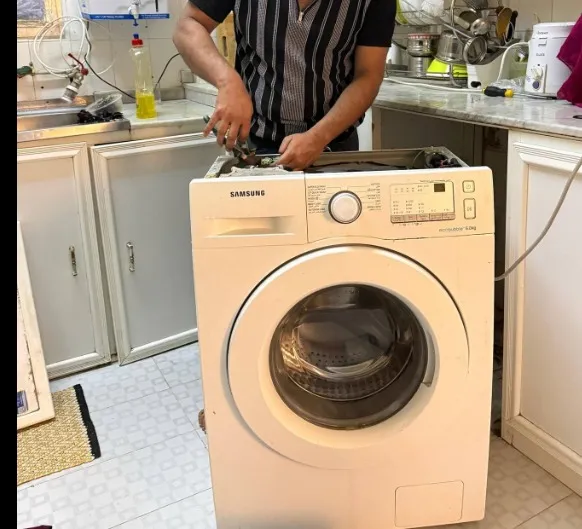 Technician repairing a washing machine leaking water in a Klamath Falls, OR home.